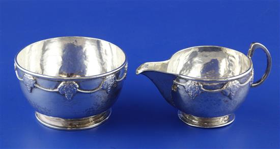 A George V Arts & Crafts silver cream jug and sugar bowl by Albert Edward Jones, 7.5 oz.